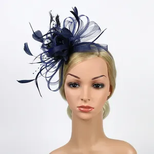 Detail of navy blue fascinator hat featuring mesh flowers, feathers, and delicate beads