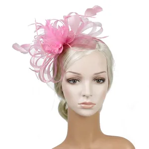 Pink feather fascinator mesh hat for weddings and parties on a blonde mannequin
