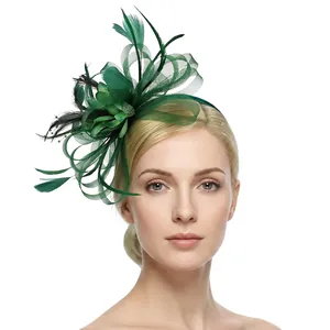 Detail of dark green vintage pillbox hat with feathers and mesh flower on a headband