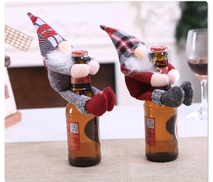 Close-up of cute Christmas gnome bottle toppers with plaid hats and white plush beards