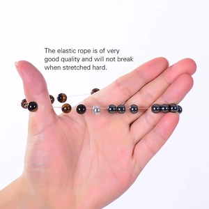 Detail showing the durable elastic string of the tiger eye and hematite beaded bracelet