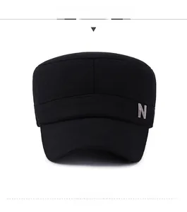 Front view of black flat top winter cap with warm wool fabric and metal 'N' detail