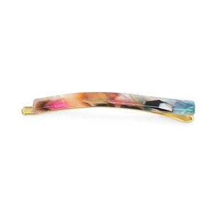Macro view of slender tortoiseshell acetate hair clip with golden metal base