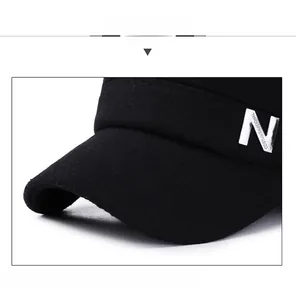 Detail view of winter wool hat featuring a silver metal N letter buckle and thick fabric