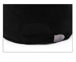 Detail of adjustable metal buckle and soft black faux fur texture on winter baseball cap
