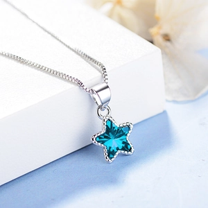 Minimalist silver necklace featuring a blue star crystal pendant on white background
