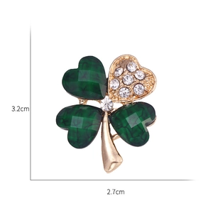 Gold four-leaf clover brooch with green stones and sparkling crystal accents