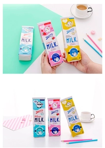 Close-up of cute cartoon milk carton pencil cases in strawberry, banana, and original flavors