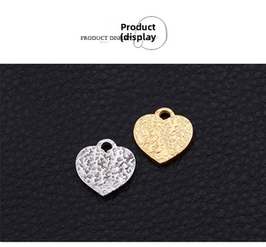 Detailed view of hammered texture heart pendants in gold and silver stainless steel