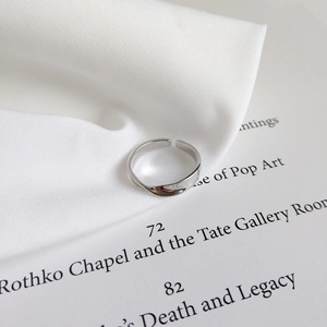Detailed close-up of S925 sterling silver ring with inner hallmark on artistic book pages