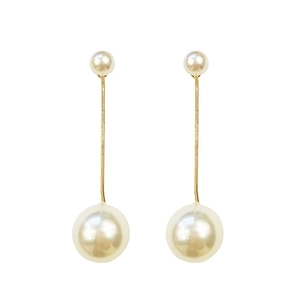 Elegant long drop earrings with double pearls and gold tassels on a white background