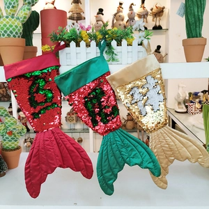 Close-up of three mermaid tail Christmas stockings with reversible sequins and quilted fabric