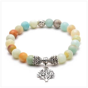 Detail of bohemian lava stone bracelet with Tree of Life charm and sunflower metal bead
