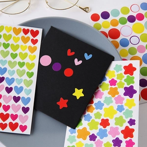 Rainbow heart and star sticker sheets for children DIY scrapbooking on white desk