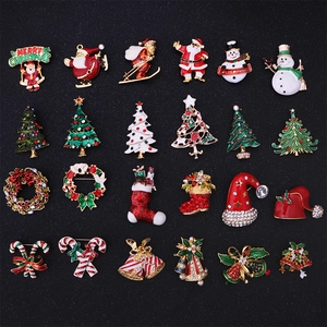 Set of 24 colorful Christmas brooches featuring snowman and tree motifs on black board
