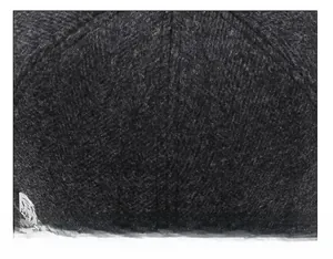 Detailed close-up of dark grey wool fabric and stitching on an outdoor winter baseball cap