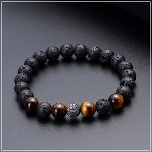 Macro shot of 8mm lava rock beads, tiger eye stones, and a micro-paved zircon bead