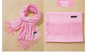 Detail of bright pink cashmere-like scarf showing texture and long fringe tassels