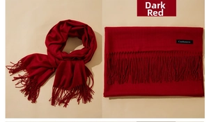 Detail of jujube red cashmere scarf showing fringe edges and soft textile texture
