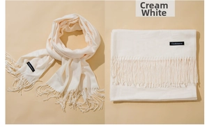 Detail of milk white cashmere-feel scarf showing thick fabric texture and long tassels