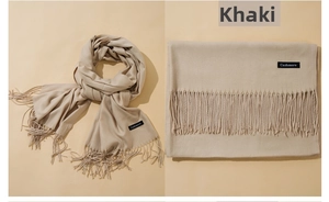 Detail view of khaki cashmere scarf with tassels showing flat fold and soft texture