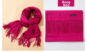 Detail of rose red cashmere scarf showing soft texture and tassel fringe craft