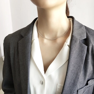 Minimalist 925 sterling silver asymmetrical bead chain worn on neck with professional look
