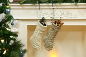 Close-up of knitted Christmas stockings in cream and khaki with cable texture decor