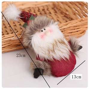 Close-up of 23cm plush Santa pendant with knit texture in a cozy woven basket