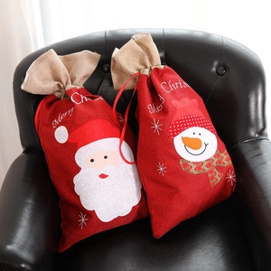 Dettagli dei sacchetti di Natale in tela con ricami di Babbo Natale e pupazzo di neve