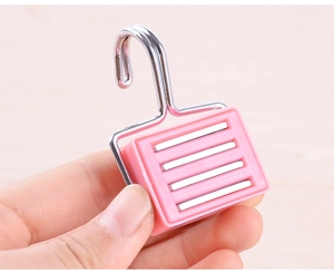 Detailed close-up of a pink magnetic hook with a metal hook and durable plastic base