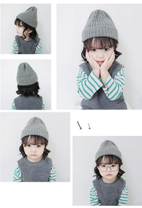Detail view of grey knitted beanie and vest set showing soft texture for toddlers