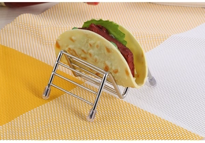 Detail of silver stainless steel taco holder with transparent protective feet sleeves
