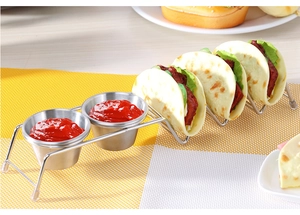Macro detail of stainless steel taco holder with three slots and two sauce cups