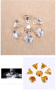 Macro detail of 2.1cm gold and silver metal bells for DIY Christmas tree hanging decor