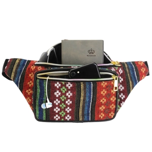 Ethnic woven waist bag with colorful stripes showing storage for phone and notepad