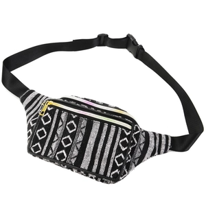 Detail of bohemian waist bag featuring black and white woven geometric patterns and gold zipper