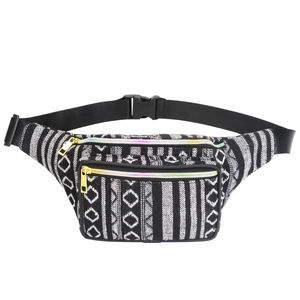 Detailed view of bohemian waist bag featuring three rainbow zippers and golden hardware