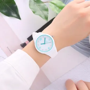 Detail of white silicone quartz watch with rhinestone markers and light blue dial accent