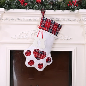 Creative dog paw Christmas stocking with red buffalo plaid and white bone decorations