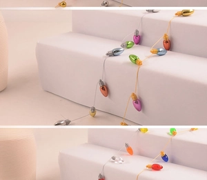 Detail view of electroplated and transparent bulb beads on colorful solid color string