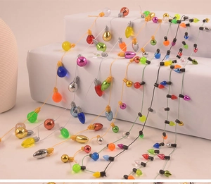 Colorful light bulb shaped bead garland hanging on white steps for Christmas decor