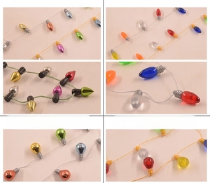 Close-up of multicolored electroplated mini bulb ornaments and festive beaded string details