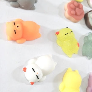 Flat lay of colorful cute cat and paw shaped squishy stress relief toys made of TPR material