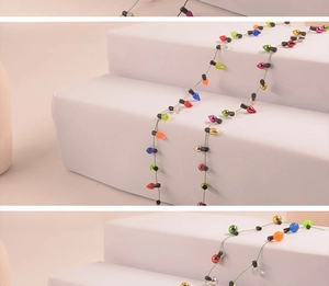 Close-up of multicolor plated plastic Christmas bead chains in various metallic colors