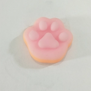 Close-up of a pink and orange squishy cat paw stress relief toy with soft texture