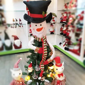 Cute snowman Christmas tree topper with black top hat and long striped knit scarf