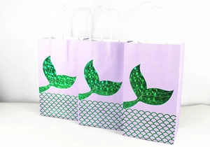 Detailed holographic purple mermaid tail gift bags with sparkling scales and white rope handles
