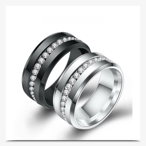 Detail shot of black and silver stainless steel rings with center row crystal inlay