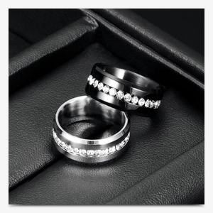 Macro detail of black and silver stainless steel rings with crystal channel set stones